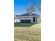 Backyard view of home with covered patio and well-maintained lawn at 3947 Nw 46Th Ter, Ocala, FL 34482