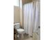 This bathroom features a standard toilet and a patterned shower curtain at 3947 Nw 46Th Ter, Ocala, FL 34482