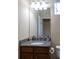 Bathroom features a granite countertop and a dark wood vanity at 3947 Nw 46Th Ter, Ocala, FL 34482