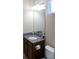 Bathroom features a granite countertop and a dark wood vanity at 3947 Nw 46Th Ter, Ocala, FL 34482