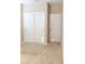Bright bedroom featuring carpeted floors, baseboard trim, a closet with sliding doors, and a single-panel door at 3947 Nw 46Th Ter, Ocala, FL 34482