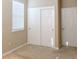Bright bedroom featuring carpeted floors, baseboard trim, a closet with sliding doors, and a single-panel door at 3947 Nw 46Th Ter, Ocala, FL 34482