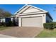 Charming single-story home featuring a two-car garage and manicured front lawn with a brick-paved driveway at 3947 Nw 46Th Ter, Ocala, FL 34482
