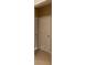 Hallway with light brown tiled flooring leading to a closed six-panel door at 3947 Nw 46Th Ter, Ocala, FL 34482