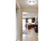 Open kitchen with modern appliances, wooden cabinets, an island, and tiled flooring, seamlessly connecting to living area at 3947 Nw 46Th Ter, Ocala, FL 34482