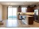 A kitchen with dark brown cabinetry, stainless steel appliances, and an island at 3947 Nw 46Th Ter, Ocala, FL 34482
