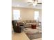 A shot of the living room, furnished with neutral colored furniture and a ceiling fan at 3947 Nw 46Th Ter, Ocala, FL 34482