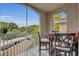 Enclosed balcony featuring tiled floors and a table set for outdoor dining at 4897 Cypress Wood Dr # 6313, Orlando, FL 32811