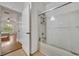 Inviting bathroom featuring a glass-enclosed tub-shower, and neutral walls at 4897 Cypress Wood Dr # 6313, Orlando, FL 32811