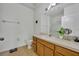 Well-lit bathroom featuring a vanity with ample counter space, a toilet, and a large mirror at 4897 Cypress Wood Dr # 6313, Orlando, FL 32811