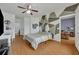 Bright bedroom with modern geometric accent wall, ceiling fan, and wood-look floors creating a cozy retreat at 4897 Cypress Wood Dr # 6313, Orlando, FL 32811