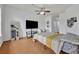 Spacious bedroom featuring a ceiling fan, wood-look floors, and ample space for a TV, desk, and mirror at 4897 Cypress Wood Dr # 6313, Orlando, FL 32811