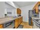 Cozy kitchen featuring wood cabinets, stainless steel sink, and views into the living area for easy entertaining at 4897 Cypress Wood Dr # 6313, Orlando, FL 32811