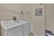 Functional laundry area features a washer, dryer, and practical shelving for storage solutions at 4897 Cypress Wood Dr # 6313, Orlando, FL 32811