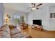 Well lit living room featuring hardwood floors, a ceiling fan and balcony access at 4897 Cypress Wood Dr # 6313, Orlando, FL 32811