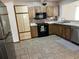 Functional kitchen featuring wood cabinets, stainless steel appliances, and tile flooring at 519 Spring Lake Rd, Ocala, FL 34472