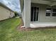 Well-maintained backyard with lush green grass, pine straw landscaping, and sliding glass doors to the house at 5255 Nw 33Rd Pl, Ocala, FL 34482