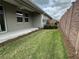 Beautifully landscaped backyard with lush green grass, privacy fence, and covered patio for outdoor enjoyment at 5255 Nw 33Rd Pl, Ocala, FL 34482