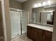 Spacious bathroom with granite counters, wood cabinets, and a glass door shower at 5255 Nw 33Rd Pl, Ocala, FL 34482