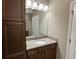 Bathroom features wood cabinets, granite counters, and tile floors at 5255 Nw 33Rd Pl, Ocala, FL 34482