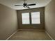 An empty bedroom with neutral walls, carpet, and a ceiling fan at 5255 Nw 33Rd Pl, Ocala, FL 34482