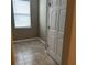 Cozy room/closet featuring tile flooring, natural light from the window, and ample storage with a closet at 5255 Nw 33Rd Pl, Ocala, FL 34482