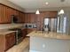 Kitchen featuring stainless steel appliances, granite countertops, and ample storage, ready for culinary adventures at 5255 Nw 33Rd Pl, Ocala, FL 34482