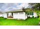 A home backyard with a private, partially enclosed patio and a well maintained lawn at 6190 Sw 84Th Pl, Ocala, FL 34476