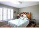 Comfortable bedroom with hardwood floors, shuttered windows, and ample natural light at 6190 Sw 84Th Pl, Ocala, FL 34476