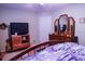 Cozy bedroom with a bed, dresser, and television set at 6190 Sw 84Th Pl, Ocala, FL 34476