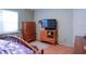 Bedroom featuring a television, a dresser and lots of natural light at 6190 Sw 84Th Pl, Ocala, FL 34476