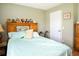 Well-lit bedroom with hardwood floors and a teddy bear collection display at 6190 Sw 84Th Pl, Ocala, FL 34476