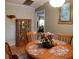 Cozy dining room with hardwood floors, curio cabinet, and round table seating four at 6190 Sw 84Th Pl, Ocala, FL 34476