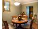 Cozy dining room with seating for four, and view into the kitchen at 6190 Sw 84Th Pl, Ocala, FL 34476