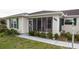 Charming home exterior featuring a screened front porch and well-maintained landscaping at 6190 Sw 84Th Pl, Ocala, FL 34476