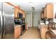 Well-lit kitchen boasting stainless steel appliances, tile backsplash, and wood cabinets at 6190 Sw 84Th Pl, Ocala, FL 34476