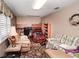 Bright living room area with lots of light, desk, comfy seating, and patterned rug at 6190 Sw 84Th Pl, Ocala, FL 34476