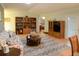 Comfortable living room with a sofa, a bookshelf, and TV at 6190 Sw 84Th Pl, Ocala, FL 34476