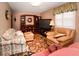 Cozy living room with patterned sofa, large flat screen tv, and a comfortable leather chair at 6190 Sw 84Th Pl, Ocala, FL 34476