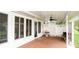 Relaxing covered patio features a ceiling fan and a view of the yard at 6190 Sw 84Th Pl, Ocala, FL 34476
