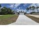 Inviting single-story home with a long driveway and attached two-car garage at 717 Marion Oaks Mnr, Ocala, FL 34473
