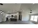 Open-concept kitchen and living area with sleek island, appliances, and modern flooring at 717 Marion Oaks Mnr, Ocala, FL 34473