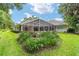 Wide backyard view of a screened-in pool and beautiful Florida landscaping at 7915 Se 12Th Cir, Ocala, FL 34480