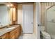 Well-lit bathroom features granite counters, raised panel cabinets, and beige tiled floors at 7915 Se 12Th Cir, Ocala, FL 34480