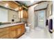 Bright bathroom featuring a granite topped vanity, water closet, and access to outdoors at 7915 Se 12Th Cir, Ocala, FL 34480