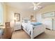 Bright bedroom with large window featuring white furniture and hardwood floors at 7915 Se 12Th Cir, Ocala, FL 34480