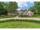 Charming stone front home with a circular driveway and lush landscaping at 7915 Se 12Th Cir, Ocala, FL 34480