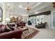 Inviting living room with comfortable seating, ceiling fan, and access to outdoor areas at 7915 Se 12Th Cir, Ocala, FL 34480
