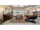 Bright living room with a fireplace, and access to the sunroom at 7915 Se 12Th Cir, Ocala, FL 34480