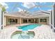 Gorgeous pool and hot tub area with screened-in enclosure and brick patio at 7915 Se 12Th Cir, Ocala, FL 34480